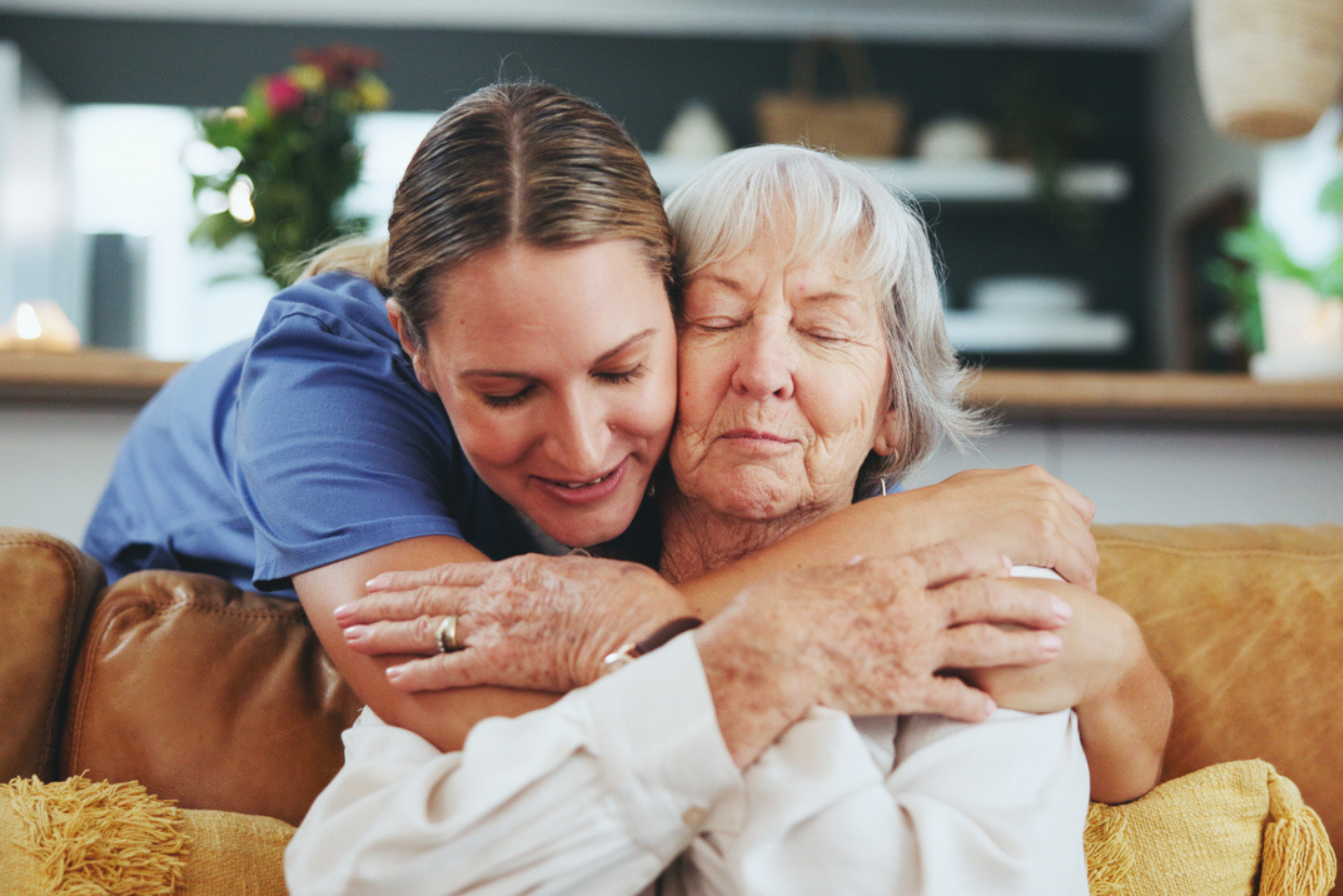 A heartfelt embrace between an elderly woman, a middle-aged adult, and a child conveys emotional support, family connection, and compassionate care.